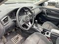 Interior of a 2019 Nissan Rogue featuring a steering wheel gearshift dashboard and front seats with fabric upholstery