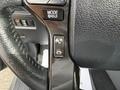 Close-up of the steering wheel controls of a 2021 Toyota 4Runner showing the MODE and HOLD buttons on the left side