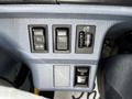 Control panel of a 2006 Hino 268 featuring buttons for setting speed cruise control and adjusting headlights