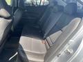 Interior view of the rear seating area of a 2017 Acura TLX featuring black leather seats and seat belts