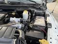 The image shows the engine compartment of a 2012 Dodge Ram 5500 featuring the engine block battery and various components including hoses and fluid reservoirs