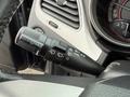 A close-up view of the control lever on the steering column of a 2013 Dodge Journey featuring various settings for lights and windshield wipers