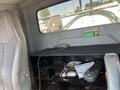 Interior view of a 2007 International 7300 showing the driver's seat and a storage area with multiple compartments and items inside