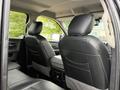 The interior of a 2018 RAM 1500 showing the back seats and armrest with black leather upholstery