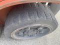 A close-up of a tire from a 2010 Toyota 7FGGU25 forklift showing the tread pattern and wheel rim
