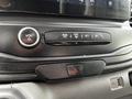 Control panel of a 2022 Ford Transit featuring volume control buttons air conditioning settings and hazard light button