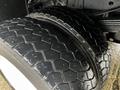 Close-up of a dual rear tire on a 2014 Ford F-550 showing a rugged tread pattern and shiny rim