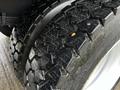 Close-up of the rugged tires of a 2013 Ford F-650 showcasing their deep tread pattern and robust design