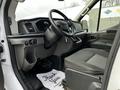 Interior of a 2020 Ford Transit showing the driver's seat steering wheel dashboard and floor mats with Thank You printed on them