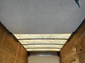 The interior roof of a 2017 Ford Econoline van showing a smooth surface with metal support beams and a light fabric lining