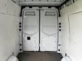 A 2021 Mercedes-Benz Sprinter van with white interior walls and double rear doors in an open position