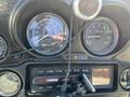 Close-up of the dashboard of a 2004 Harley-Davidson Flhtcui featuring speedometer and tachometer with gauges and a radio display