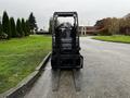 A 2017 Toyota 8FCGCU25 forklift with black chassis and extended forks facing forward in a parking lot setting