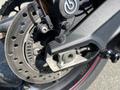 Close-up of the rear braking system on a 2018 Triumph Street Triple RS showcasing the brake disc caliper and metallic components