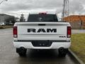 A white 2022 RAM 1500 Classic truck viewed from the rear showcasing the large RAM logo and dual exhaust pipes