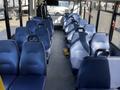 Interior of a 2017 Chevrolet Express with blue upholstered seats arranged in rows and aisles