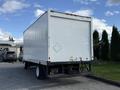 2007 GMC W5500 18 foot cube van with a white cargo box and a black step bumper parked in a lot with no visible cargo or markings on the sides