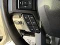 Steering wheel controls of a 2020 Ford F-550 featuring buttons for setting cruise control and adjusting settings