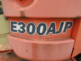 Close-up of a 2009 JLG E300AJP machinery label displaying model number in bold black letters against an orange background