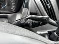 A close-up of the control stalk on a 2017 Ford Transit 350 featuring various functions including turn signals and windshield wipers