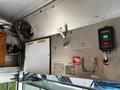 Interior view of a 2009 Morgan Olson Workhorse showing metal panel with controls and a fan, a warning label, and a whiteboard mounted on the wall