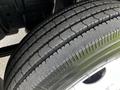 Close-up of a 2016 Isuzu NQR tire showcasing tread patterns and sidewall detail
