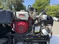 A VMAC G30 engine mounted on a platform with various hoses and attachments visible along with a red generator component