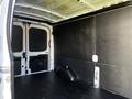 2022 Ford Transit van interior with a large cargo space featuring a black wall panel and a flat floor