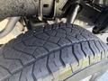 A close-up view of a 2015 Toyota Tacoma tire showing detailed tread design and texture