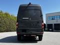 A 2017 Mercedes-Benz Sprinter van viewed from the rear with a dark exterior and prominent taillights