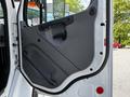 The image shows the interior door of a 2012 Freightliner M2 106 with a simple gray panel handle and a small black grip for closing the door