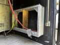 A metal frame attached to the interior of a 2016 Ford F-550 with a red hose and a yellow rope visible in the scene