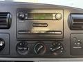 Dashboard of a 2006 Ford F-550 featuring a radio display and control knobs for volume and temperature settings