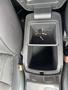 A 2015 Kia Sorento's center console with an empty storage compartment and a set of car keys resting inside