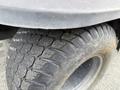 Close-up of a tire from a 2011 Kubota RTV 1140 CPX showcasing a rugged tread pattern and textured surface
