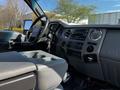 Interior view of a 2016 Ford F-550 showing the dashboard steering wheel and center console with controls and storage compartments