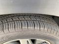 A close-up view of a Kia Sorento tire showing a tread pattern with visible wear indicative of usage