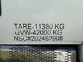 A white 2009 International 7500 truck displaying identification numbers and weight specifications on its side panel