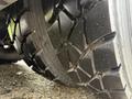 Close-up of a rugged truck tire showcasing deep treads designed for traction and stability on various surfaces