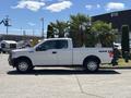 A 2016 Ford F-150 in white with a four-door cab and a standard truck bed displayed from the side