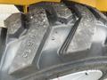 Close-up of a rugged tire from a 2024 AGT Industrial KRW23 Mini Loader with deep treads and visible wear markings