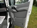 Interior door panel of a 2017 Mercedes-Benz Sprinter featuring a gray finish and a built-in storage compartment