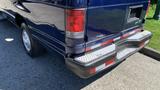 A blue 2013 Ford Econoline van showing the rear bumper and taillights