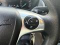 Close-up of a steering wheel control panel from a 2021 Ford Transit Connect featuring buttons for phone controls and audio settings