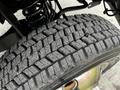 Close-up of a heavily treaded tire from a 2019 Ford F-550 showcasing deep grooves and a robust design designed for durability and traction