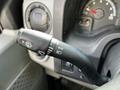 A close-up of the turn signal and headlight control stalk from a 2013 Ford Econoline with various symbols indicating functions