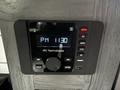 A digital control panel featuring a display that shows the time as PM 1130 with buttons for Bluetooth AM FM and zone controls