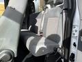 Interior view of the rear seat of a 2011 Ford F-450 SD featuring gray fabric upholstery with seat belts and a simple design