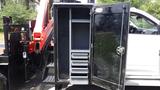 A 2014 RAM 5500 with an open black tool compartment featuring multiple shelves and a secure door mechanism