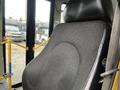 A close-up of the driver's seat in a 2017 Chevrolet Express featuring a textured black fabric design with a visible logo on the side